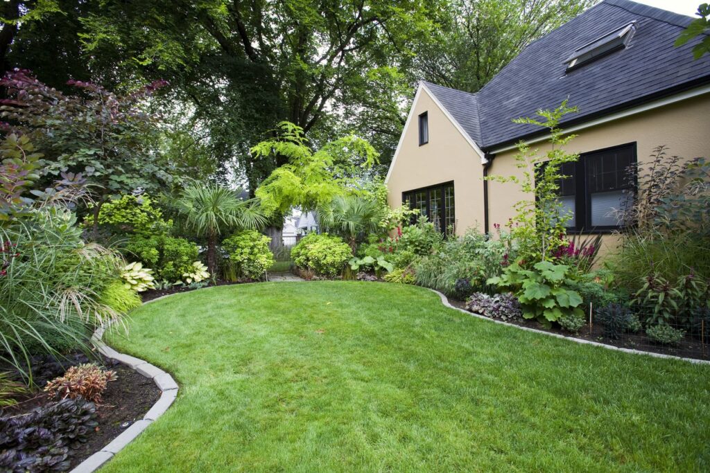 yard with beautiful landscaping and freshly mowed grass