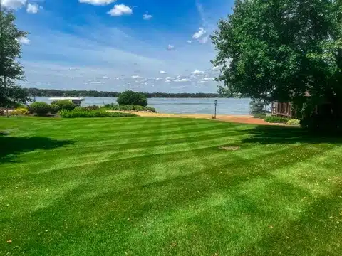 mowed lawn next to lake